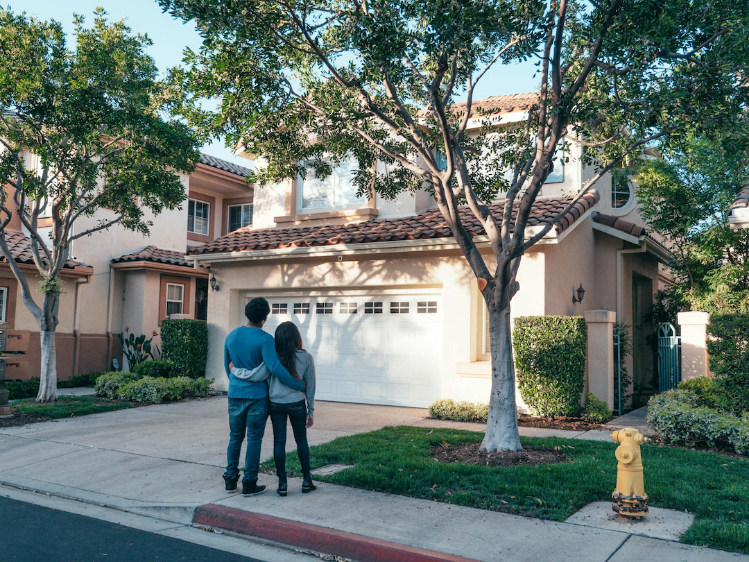 Two people looking at a house.